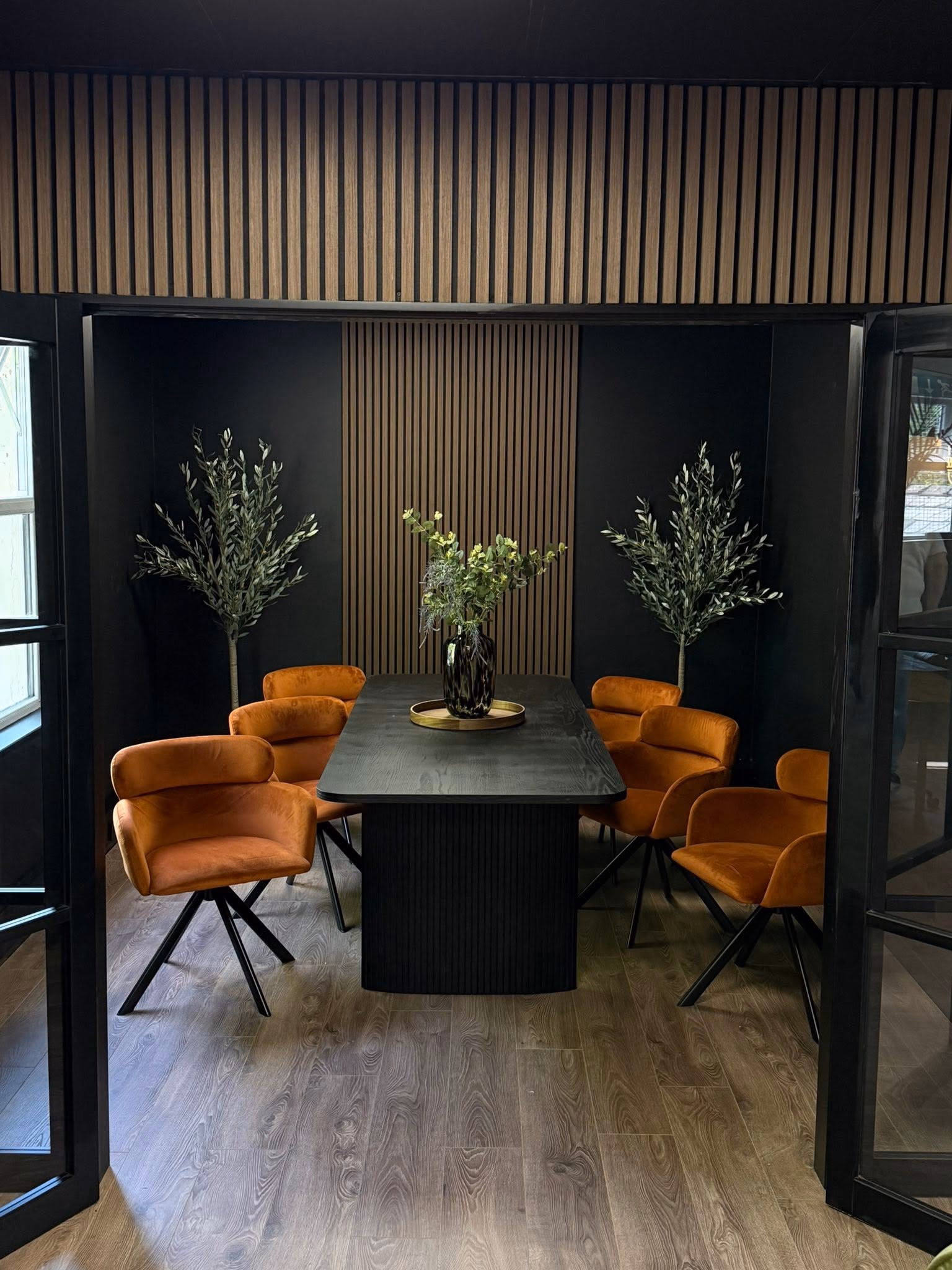 Private meeting room with an oval table and velvet chairs