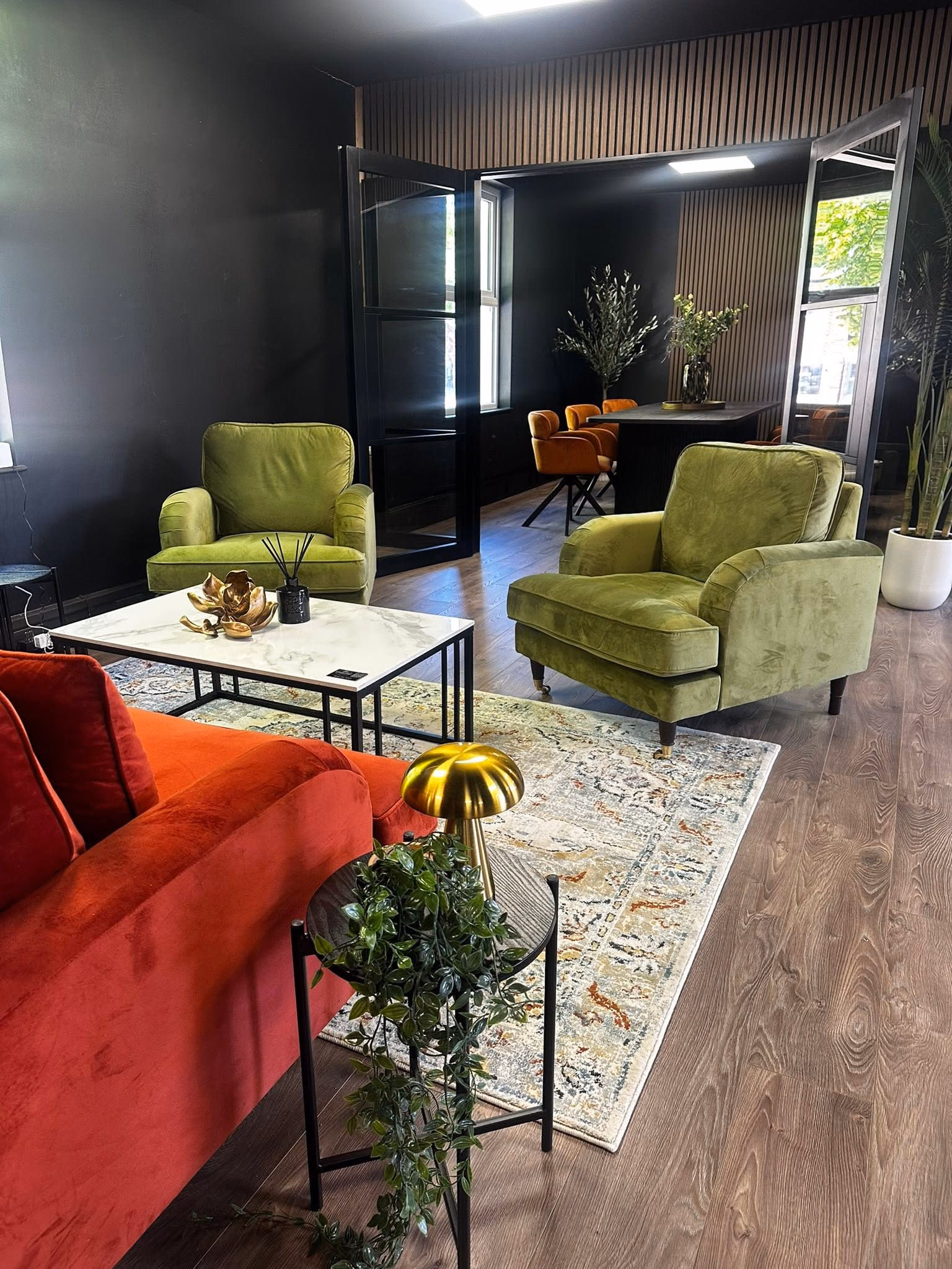 Social lounge with velvet armchairs and a rug